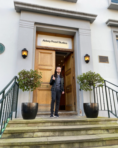 Michael J. Keplinger standing on top of the stairs in front of the entrance of Abbey Road Studios, London